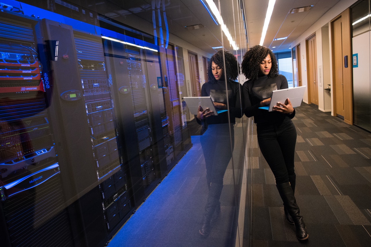 Woman standing beside computer servers